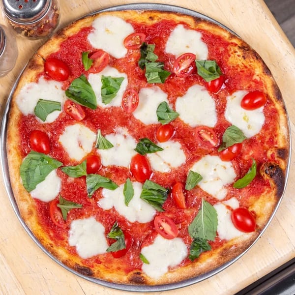 A L'arte Della Pizza Brooklyn Margherita pizza with fresh mozzarella, basil, and cherry tomatoes.